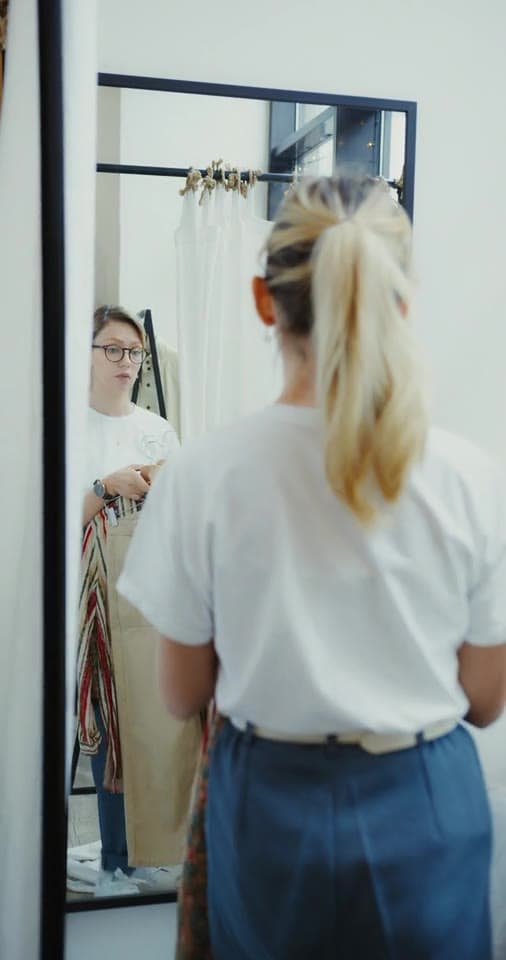 Example video: a creator trying three outfits with one white shirt in front of a mirror