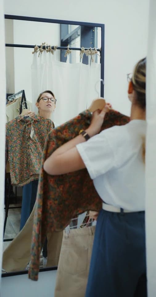 Example clip 3 of 3, from 2:40: a creator trying on a patterned top in a mirror