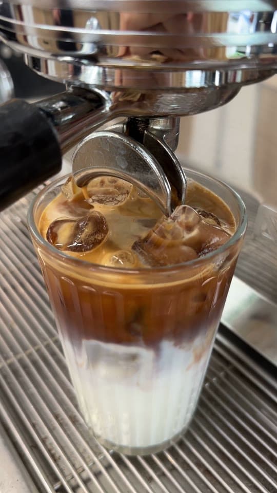Example video: espresso pouring over ice and milk in a ribbed glass